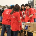Volunteers stuffing goodie bags for the fair
